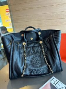Chanel Tote Bag with Gold Chain and Paris Embossing on white background