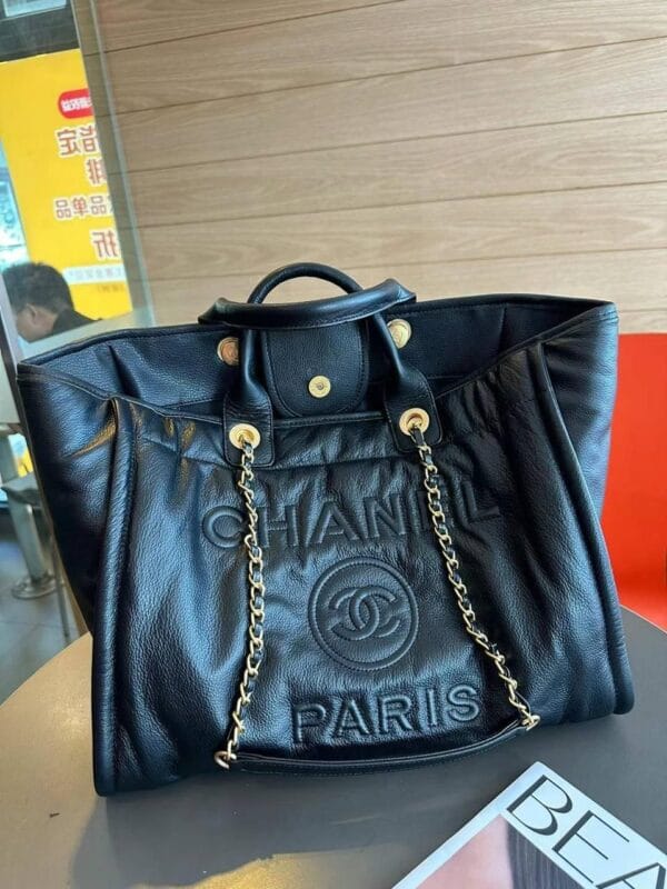 Chanel Tote Bag with Gold Chain and Paris Embossing on white background